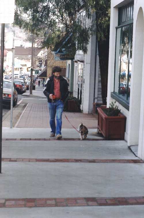 A local character walking his dog downtown just north of courthouse park